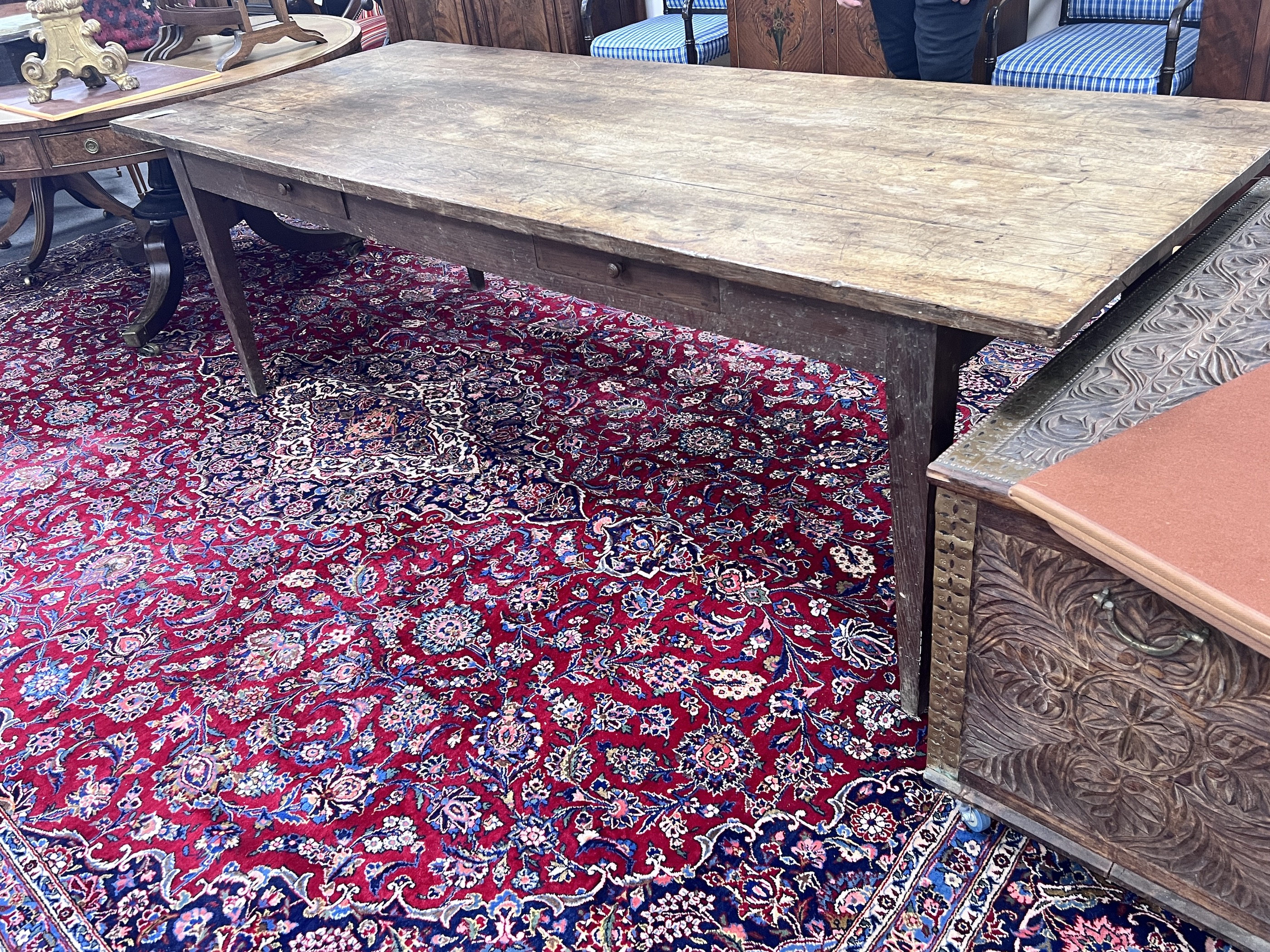 A 19th century French oak two drawer farmhouse table with a four plank top, on square tapered legs, length 239cm, depth 93cm, height 74cm